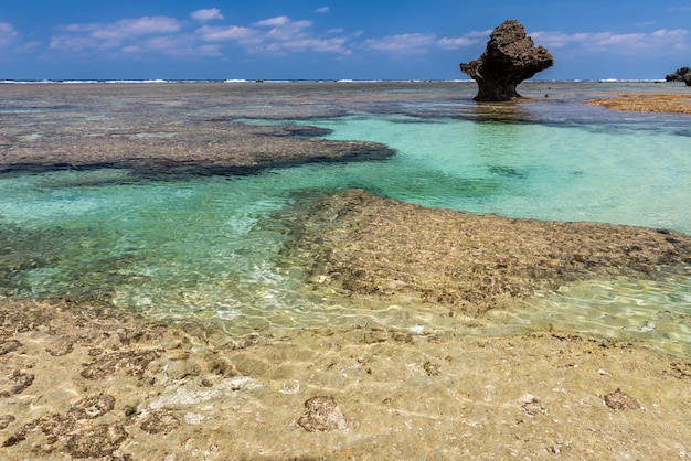 Breathtaking view of a crystal clear natural pool glistening sea surface coastal rocks.