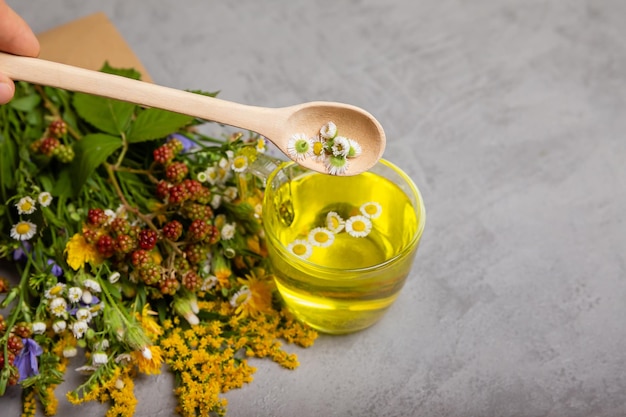 Brewed delicious herbal beverage on a grey background