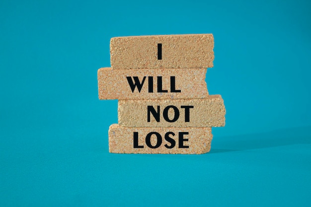 Brick blocks with text I will not lose Beautiful blue background copy space Positive Winning Quote