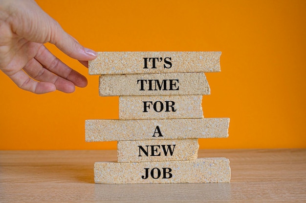 Brick blocks with text sign showing Its time for a new job Businessman hand