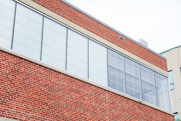 A brick building with a white window that says " s " on the top.