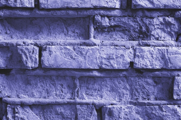 Brick wall background tinted in a trendy Very Peri color