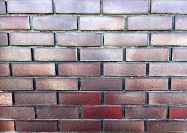 Brick wall background with shades of red and purple. Brick wall texture