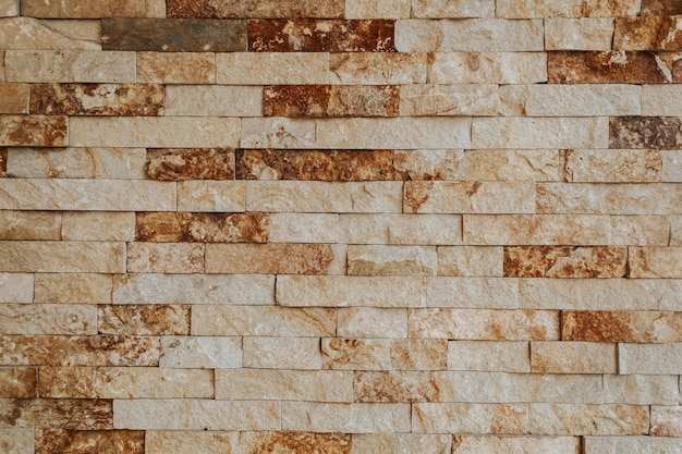 A brick wall with brown and white bricks