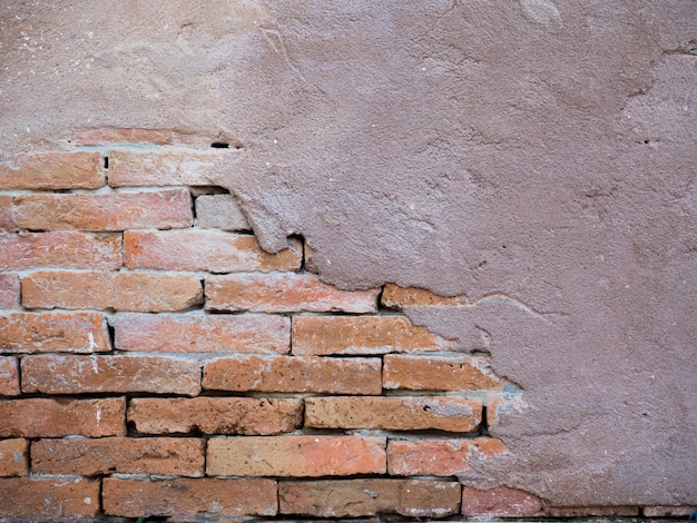 brick wall with peeling plaster concrete