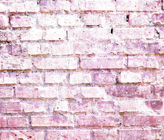 A brick wall with pink paint that says'brick'on it