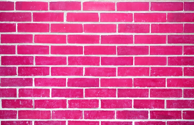 a brick wall with a pink and white brick background.