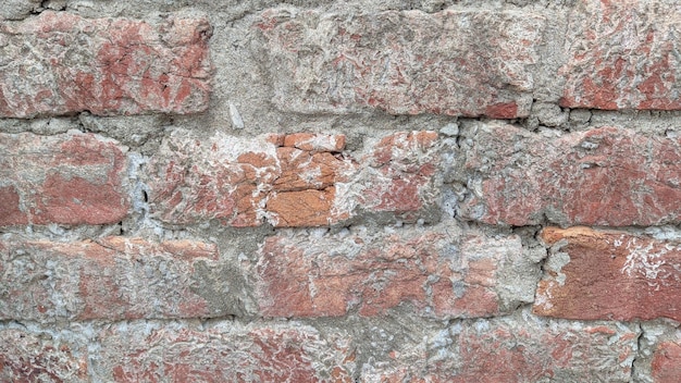 A brick wall with a red brick