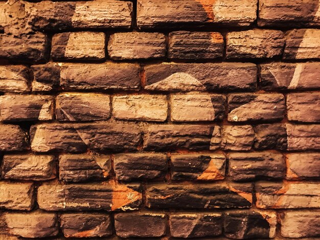 A brick wall with a star and a leaf on it