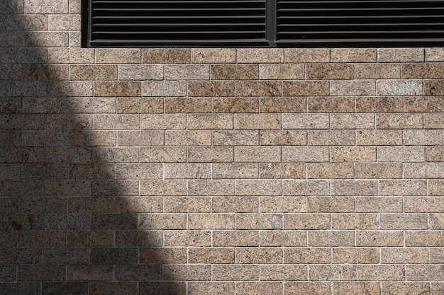 Brick wall with ventilation grilles providing a unique backdrop for design