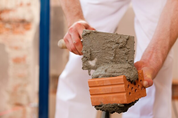 Bricklayer working on construction site