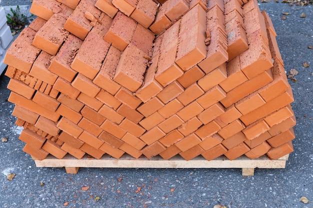 Bricks are stacked on a building yard in the street