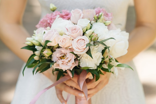 Bridal morning details. Wedding beautiful bouquet in the hands of the bride, selectoin focus