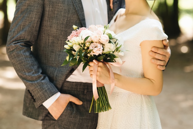 Bridal morning details. Wedding beautiful bouquet in the hands of the bride, selectoin focus