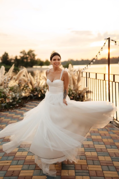 Bride against the background of a yellow sunset