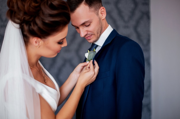 bride arranging groom's flower