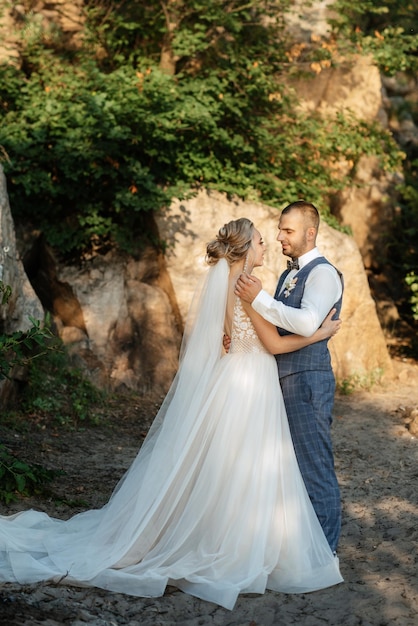 Bride blonde girl and groom near the river