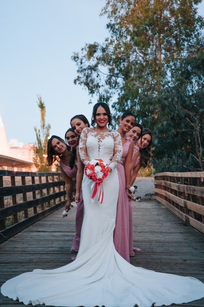 Bride and bridesmaids looking at the camera