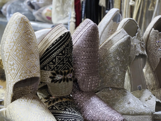 Bride festive shoes Colorful handmade leather slippers waiting for clients at shop in Fes, next to tanneries, Morocco