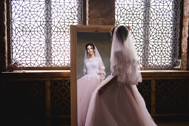 The bride gathers in the morning near the mirror