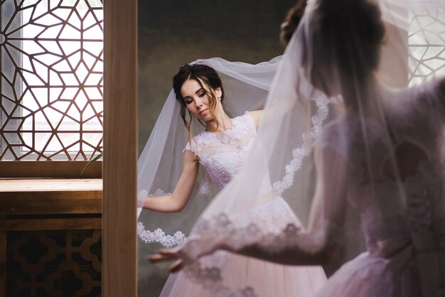 The bride gathers in the morning near the mirror