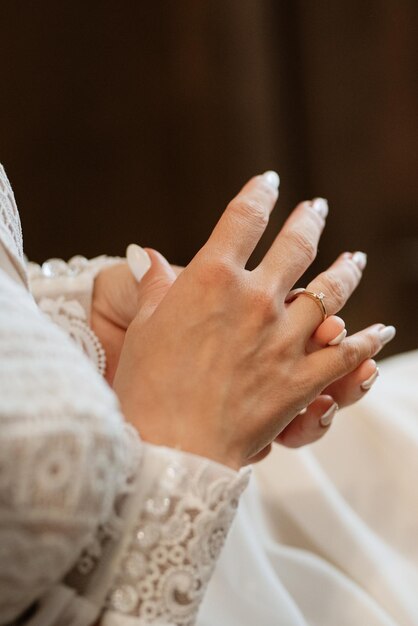 The bride gently touches her dear engagement ring