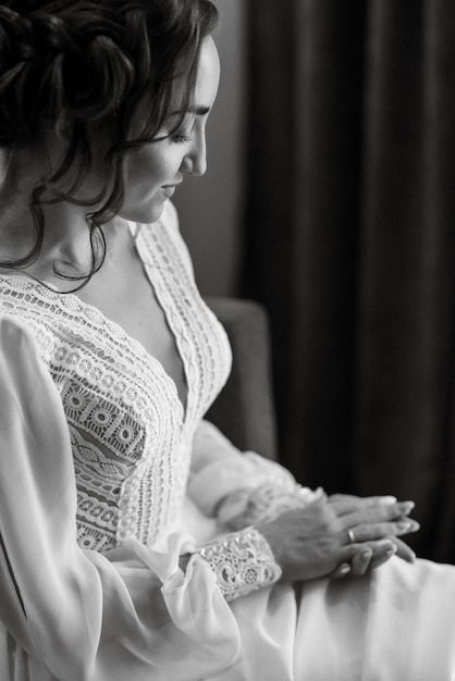 The bride gently touches her dear engagement ring