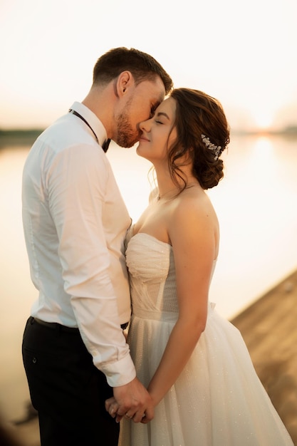 bride and groom against the backdrop of a yellow sunset