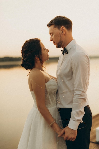 bride and groom against the backdrop of a yellow sunset