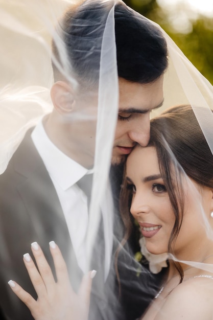 a bride and groom are kissing in front of a green background