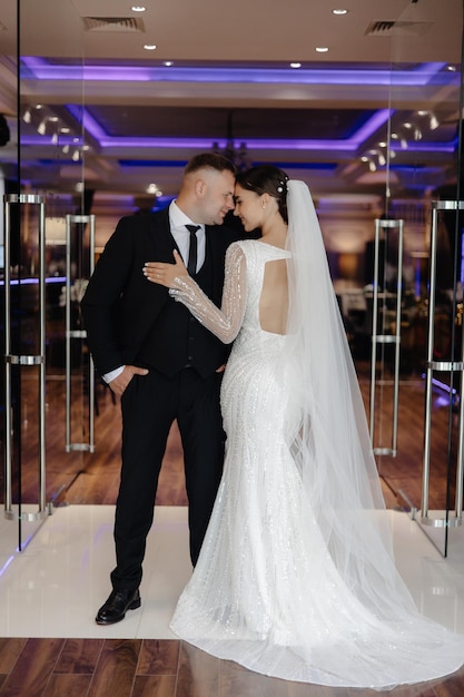 a bride and groom are posing for a photo in front of a mirror