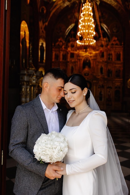 a bride and groom are standing in front of a large window