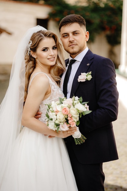 Bride and groom on the background of beautiful architecture. Beautiful old building. Wedding.