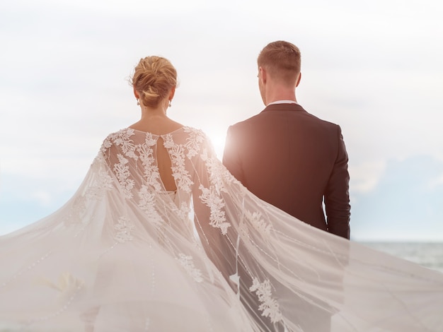 Bride and groom on the beach with a romantic moment