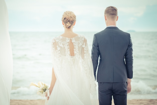 Bride and groom on the beach with a romantic moment