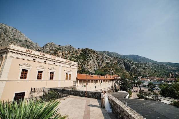 Bride and groom dance in the square in front of the napoleon theater kotor montenegro