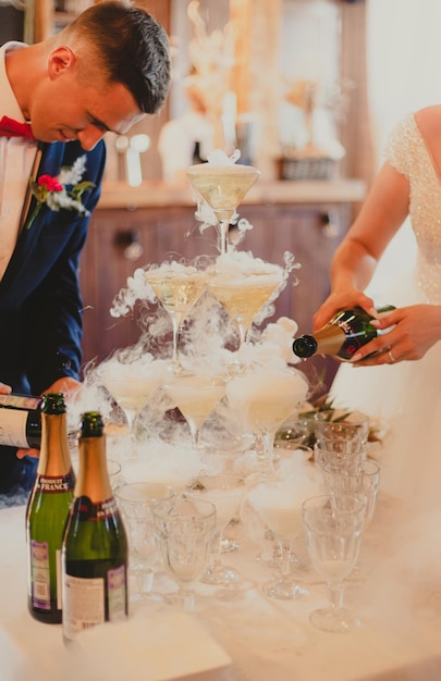 The bride and groom fill the champagne fountain