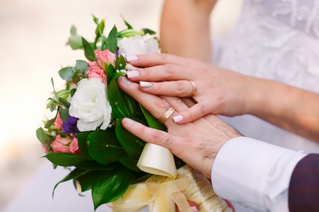 Bride and groom hands, close-up.