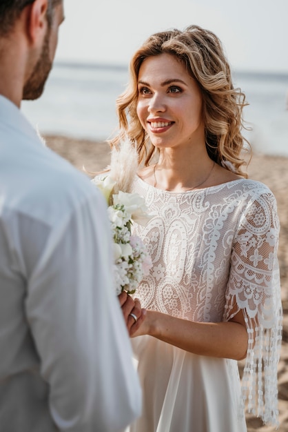 Bride and groom having a beach wedding