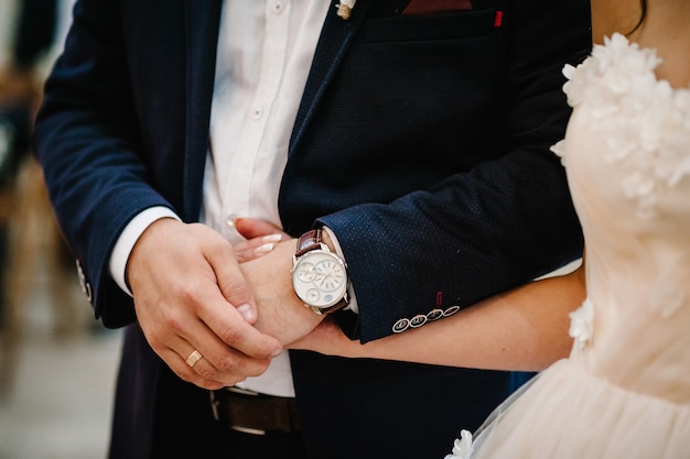 The bride and groom hold hands on the wedding ceremony bottom view Engagement