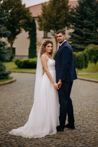 the bride and groom hold hands