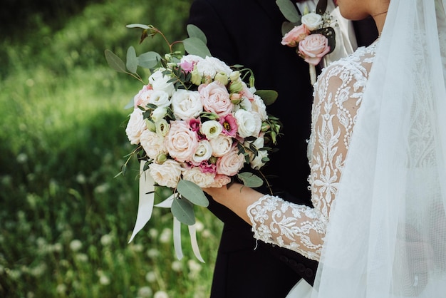 Bride and groom hold a wedding bouquet of flowers 1