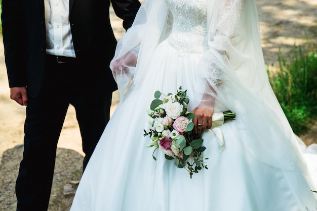 Bride and groom hold a wedding bouquet of flowers 2