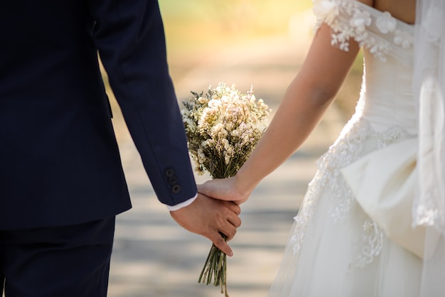 Bride and Groom Holding Hands outdoors in wedding event