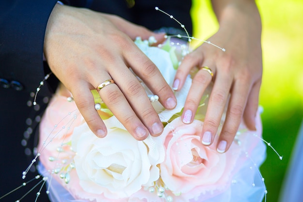 Bride and groom holding hands with a bouquet