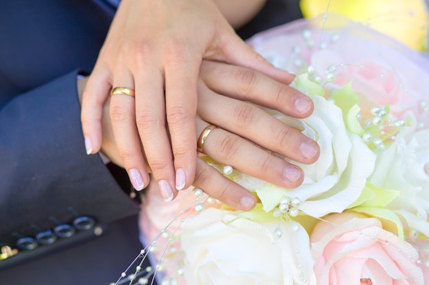 Bride and groom holding hands with a bouquet