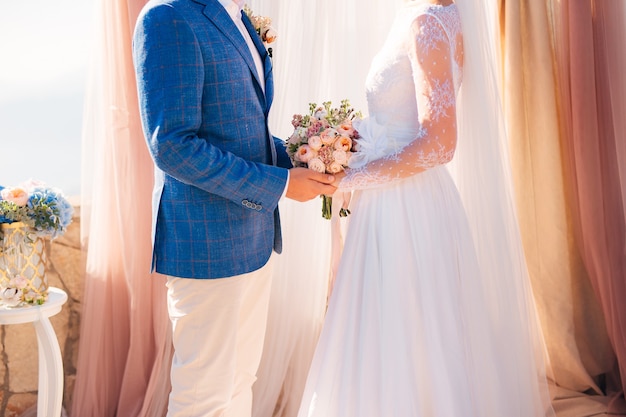 Bride and groom holding hands