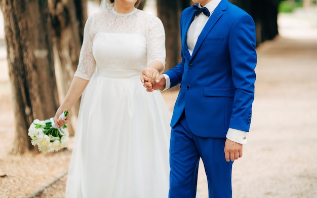 Bride and groom holding hands