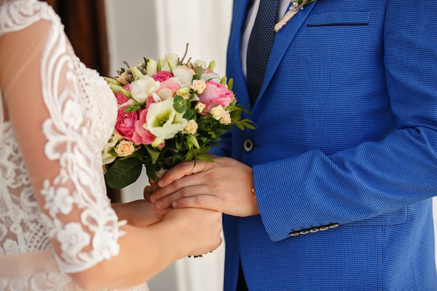 Bride and groom holding wedding bouquet