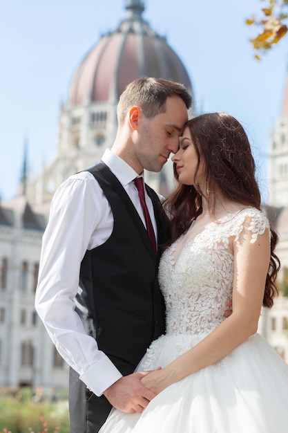 Bride and groom hugging in the old town street. 